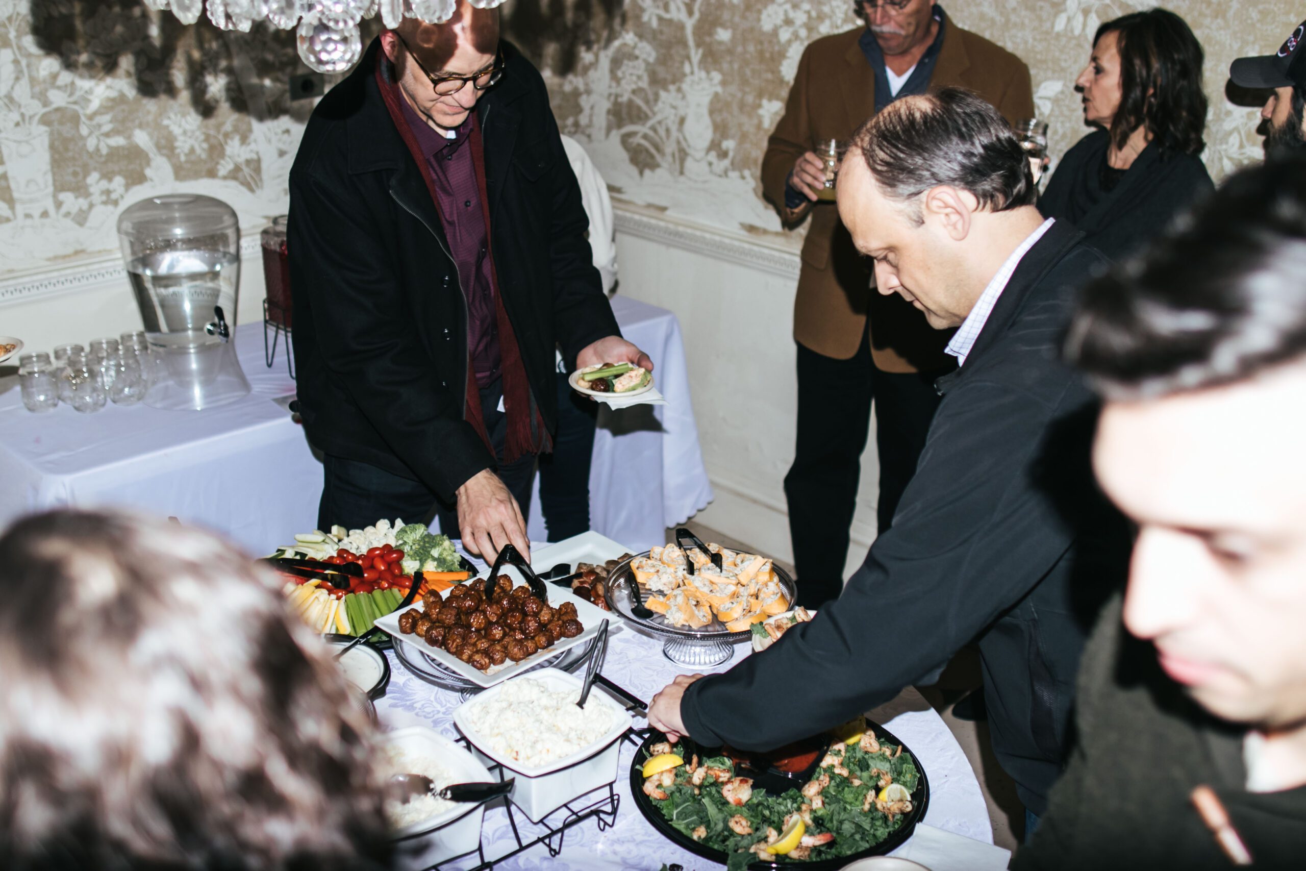 Table with many different assorted food items at a Christmas party