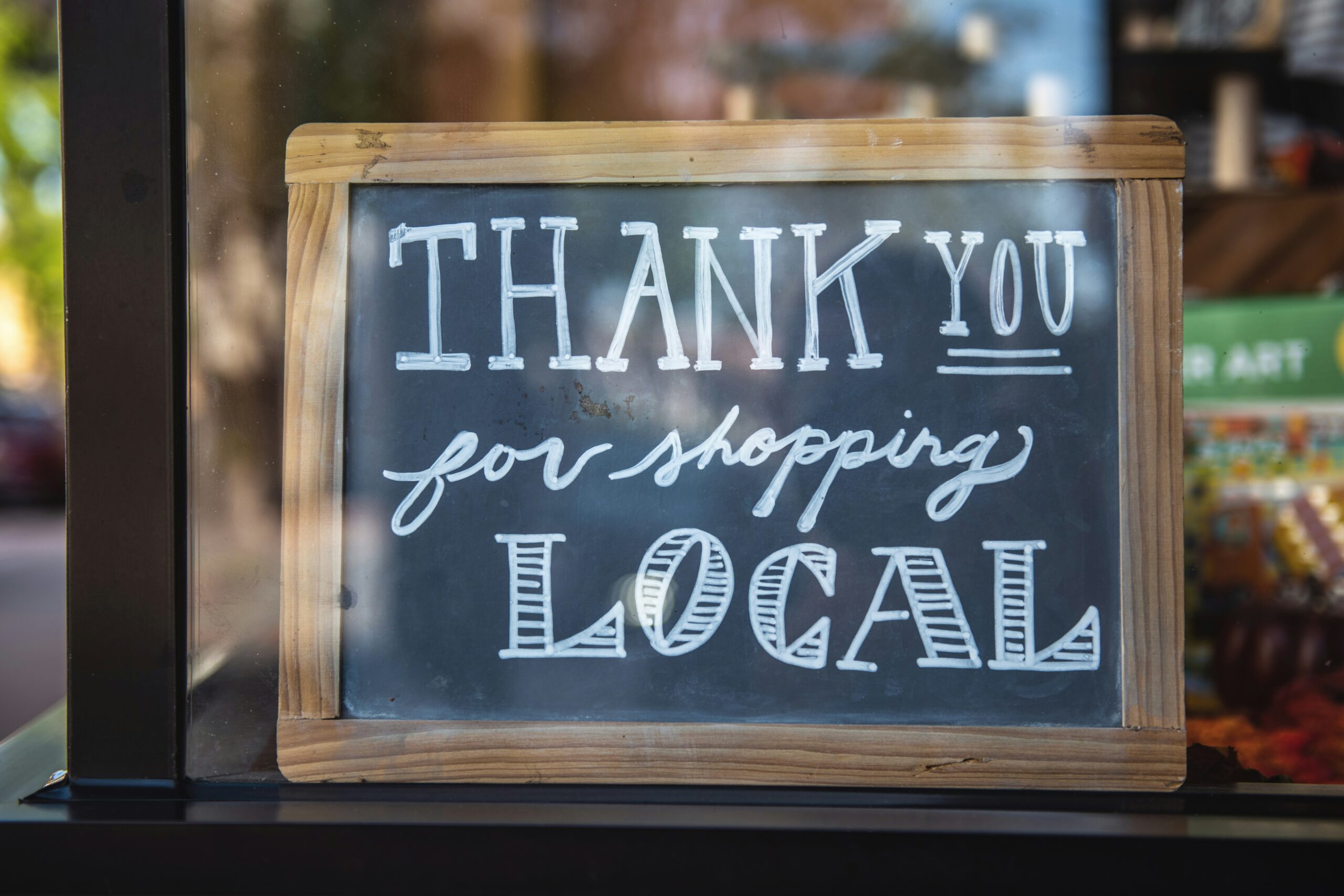 Sign outside of business that says "Thank you for Shopping Local"