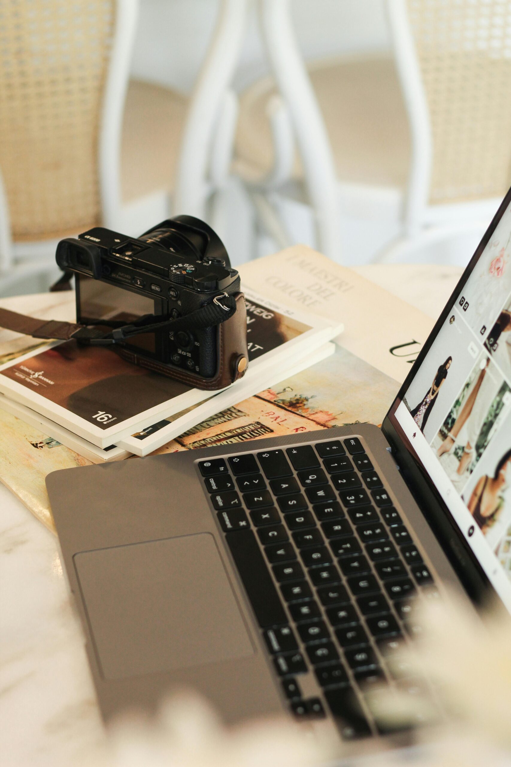 Camera Sitting next to computer working on an email marketing campaign