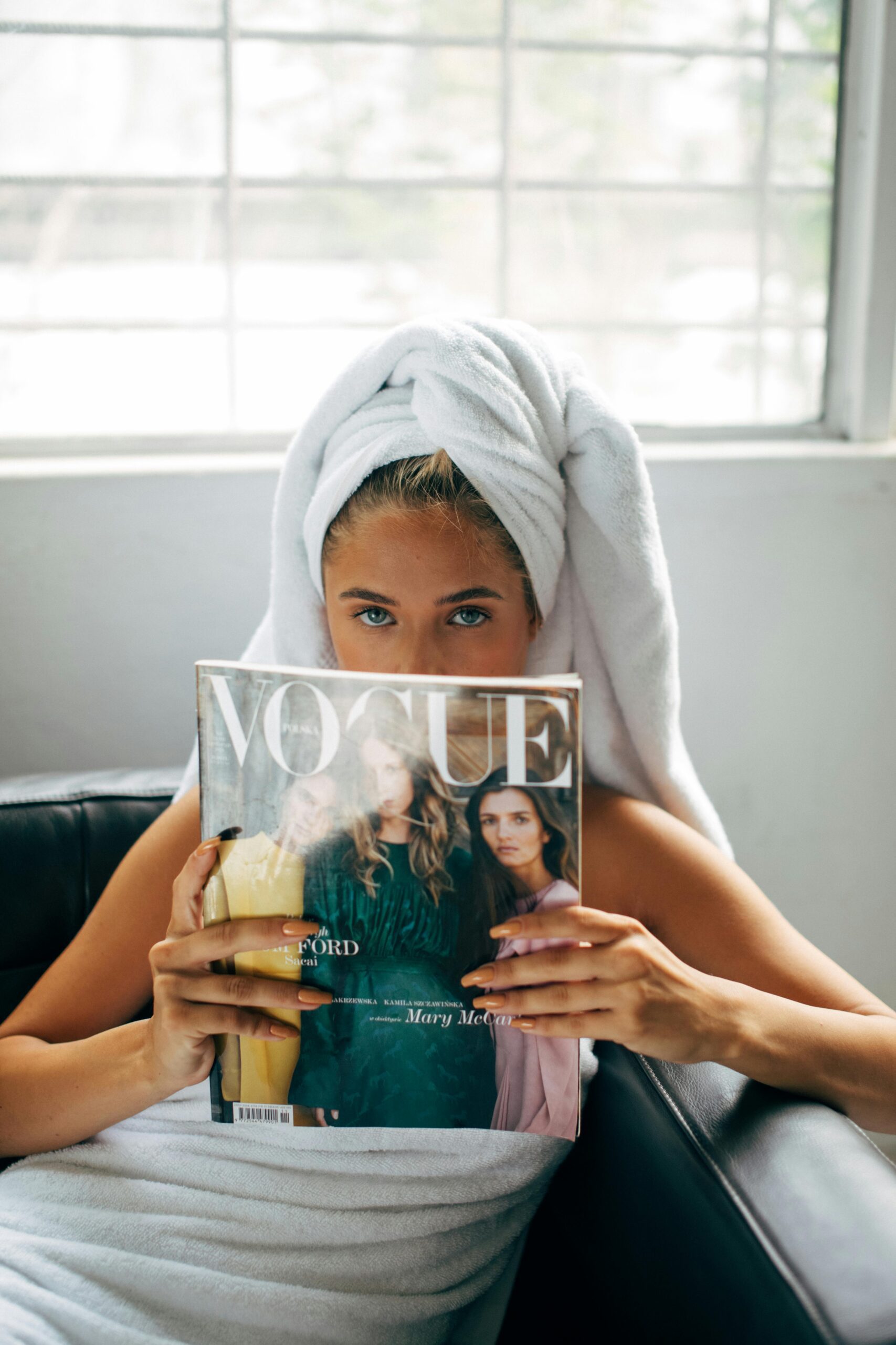 Person Reading a Vouge Magazine in a Towel