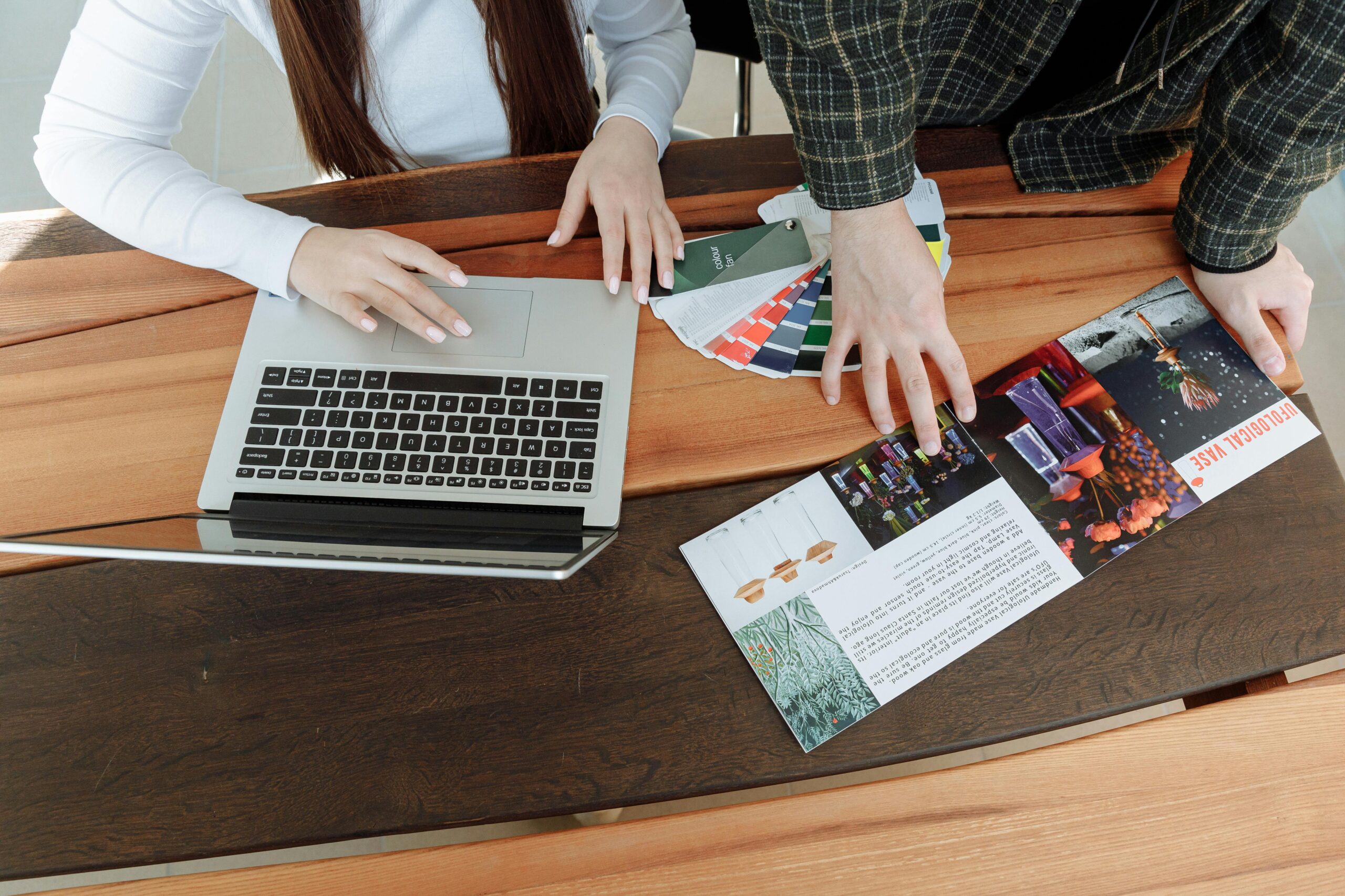 Two people looking at design and branding materials